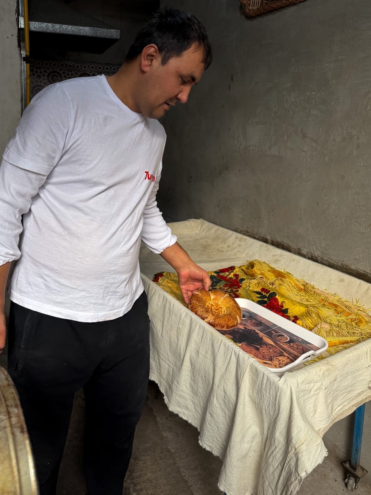 a man with cooked uzbek bread