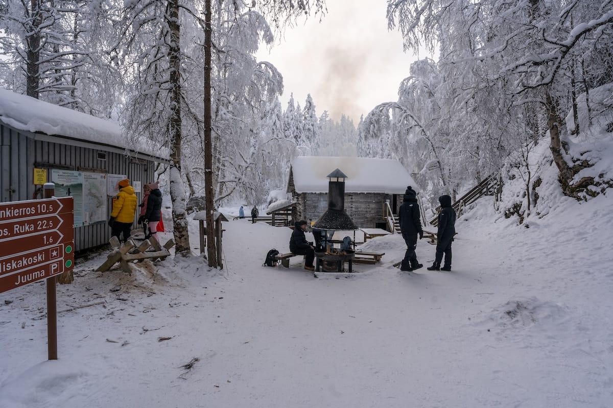 people standing around a fire in a snowy location