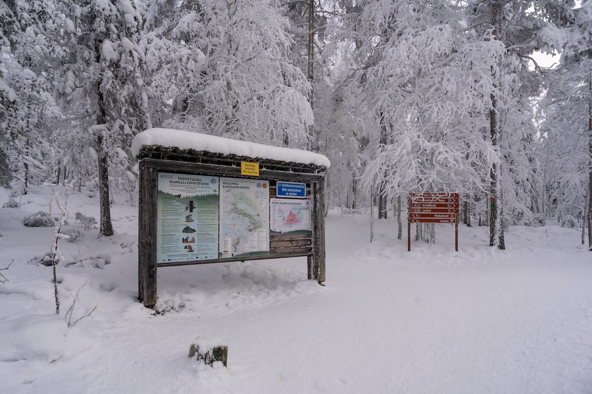 A sign in a snowy forest