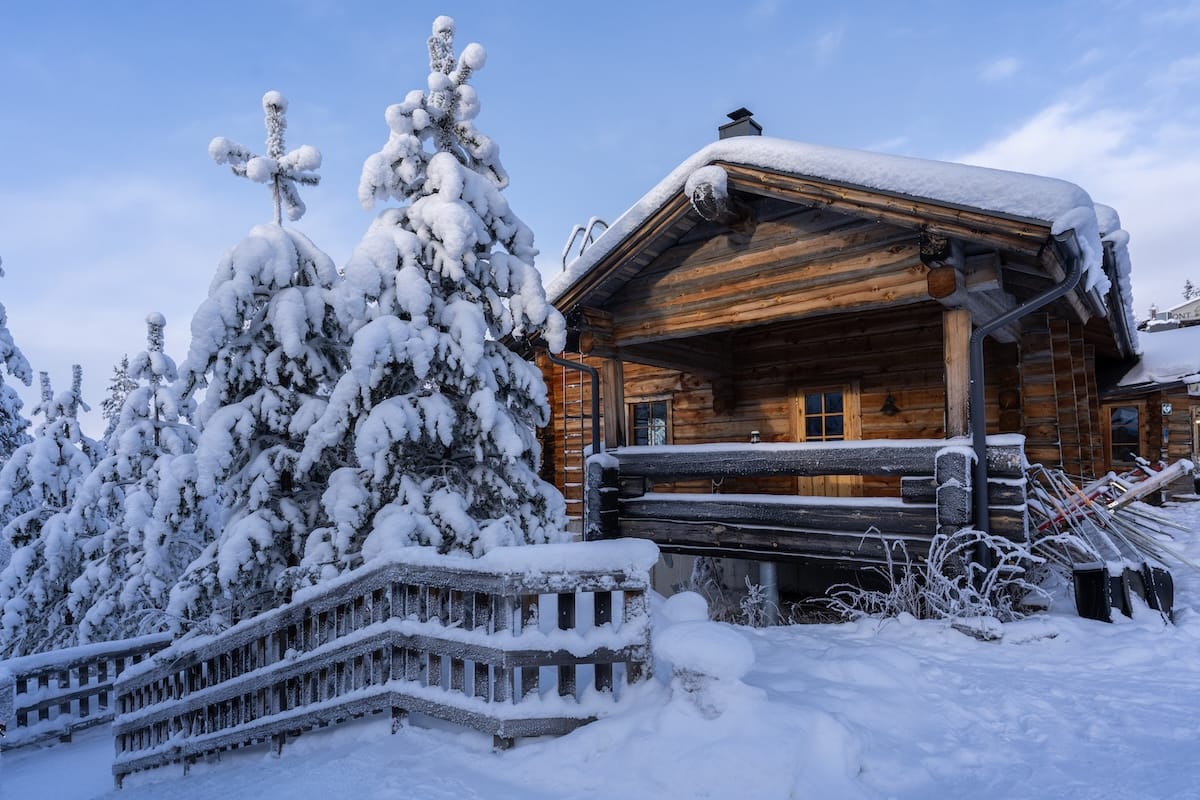 a wooden building beside snowy trees