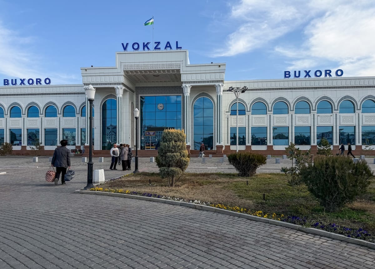 a train station with a modern white building