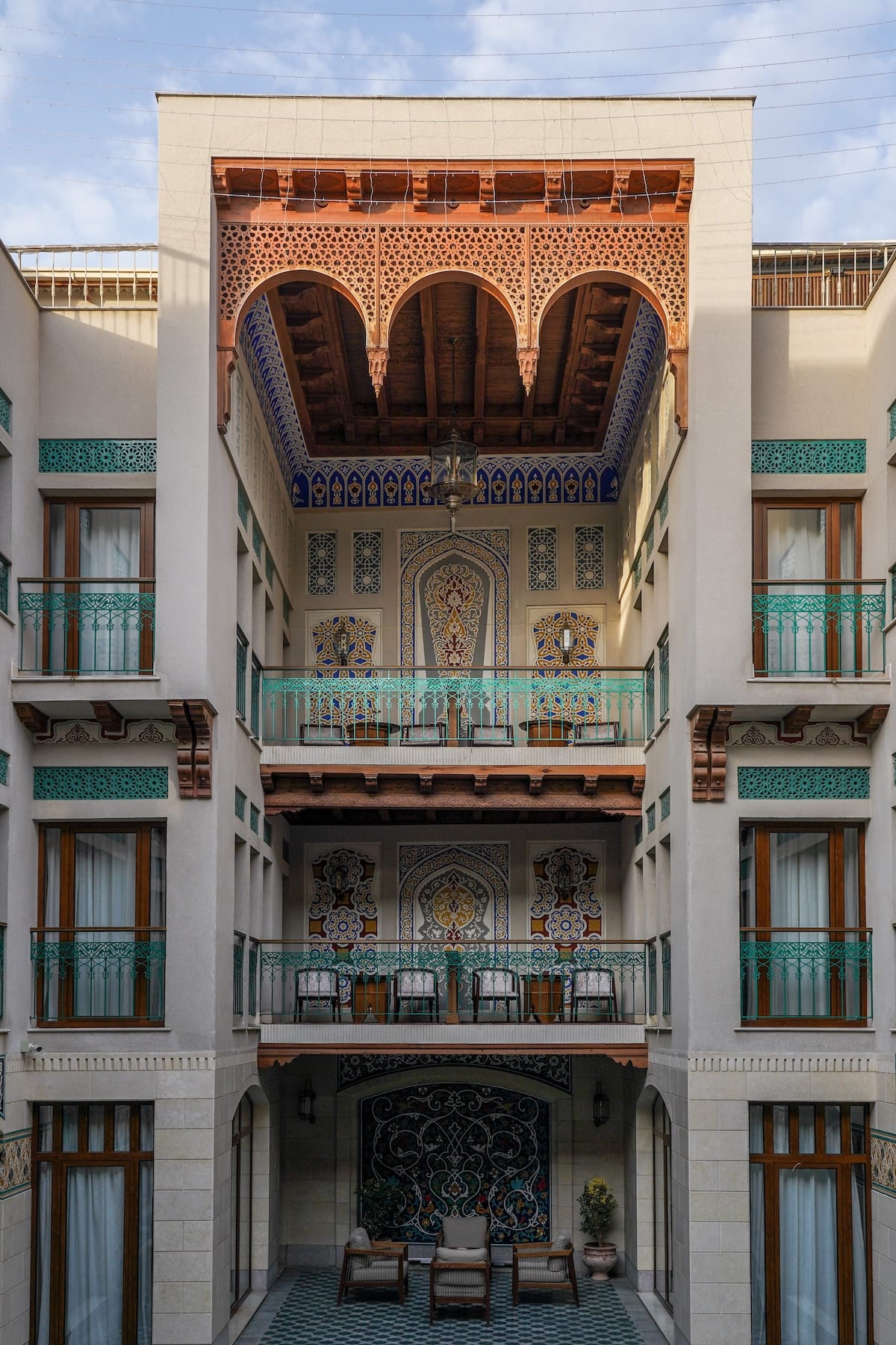 a three story shot of a hotel with colorful decor