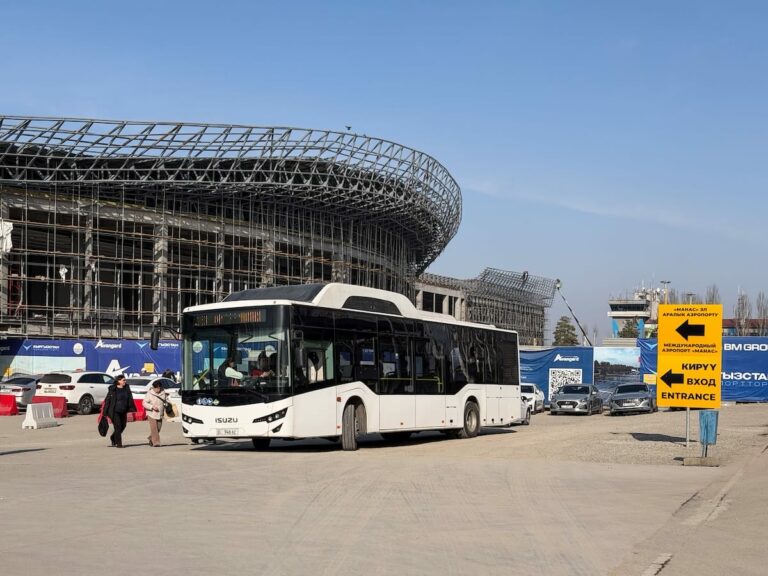 a bus in front of an airport terminal under construction
