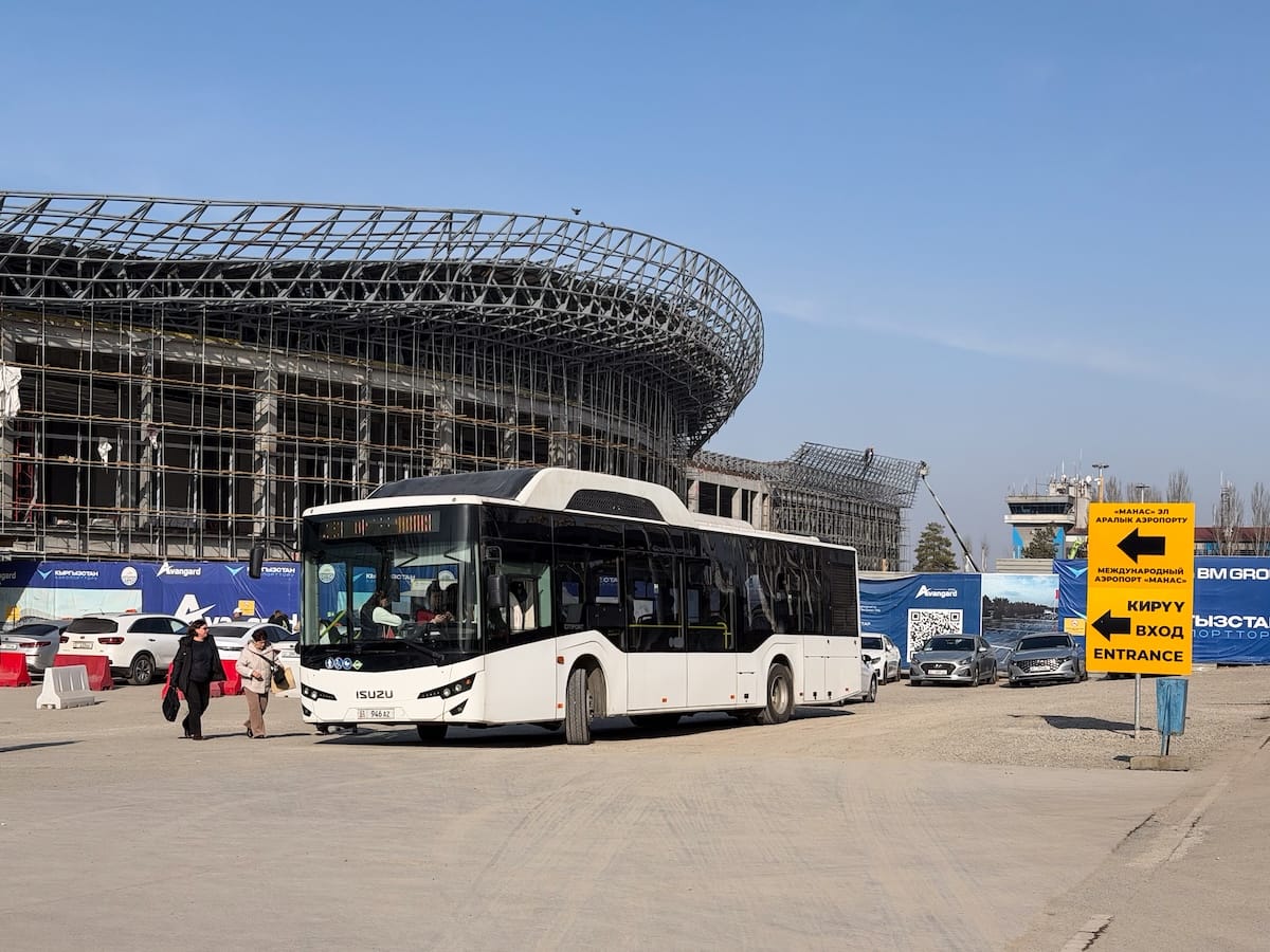 a bus in front of an airport terminal under construction