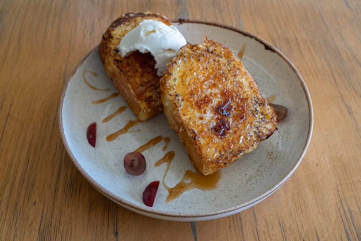two pieces of french toast with vanilla ice cream on a plate