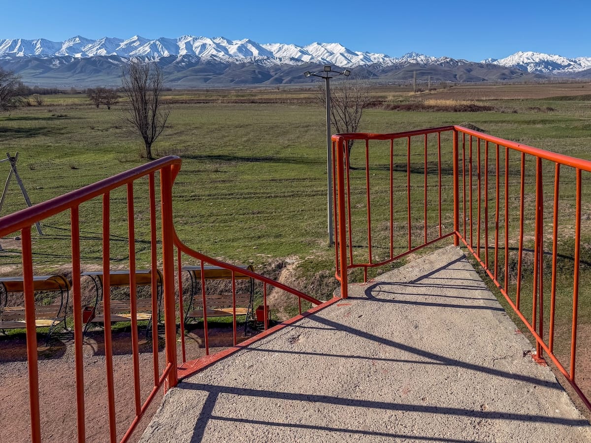 a set of red stairs with a view of the mountains