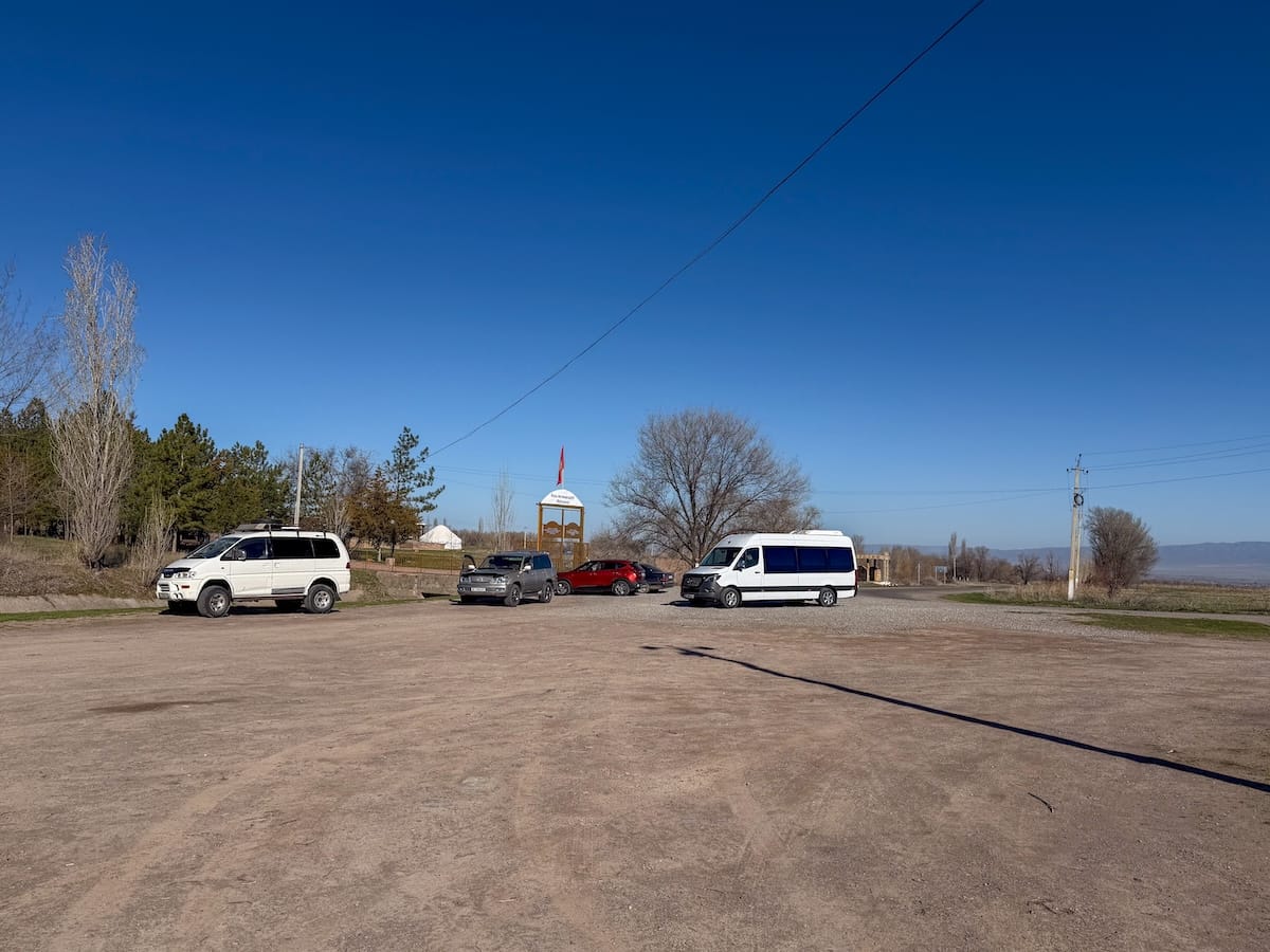 a parking lot with two white vans in it