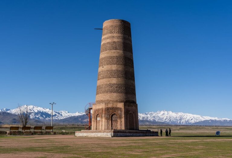 A photo of the burana tower in front of the mountains