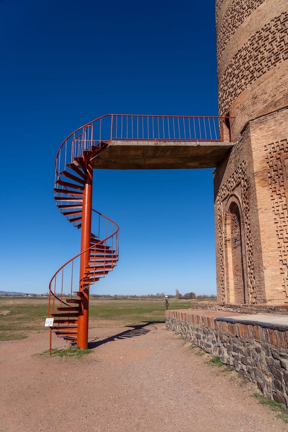 a set of red spiral stairs leading to the tower