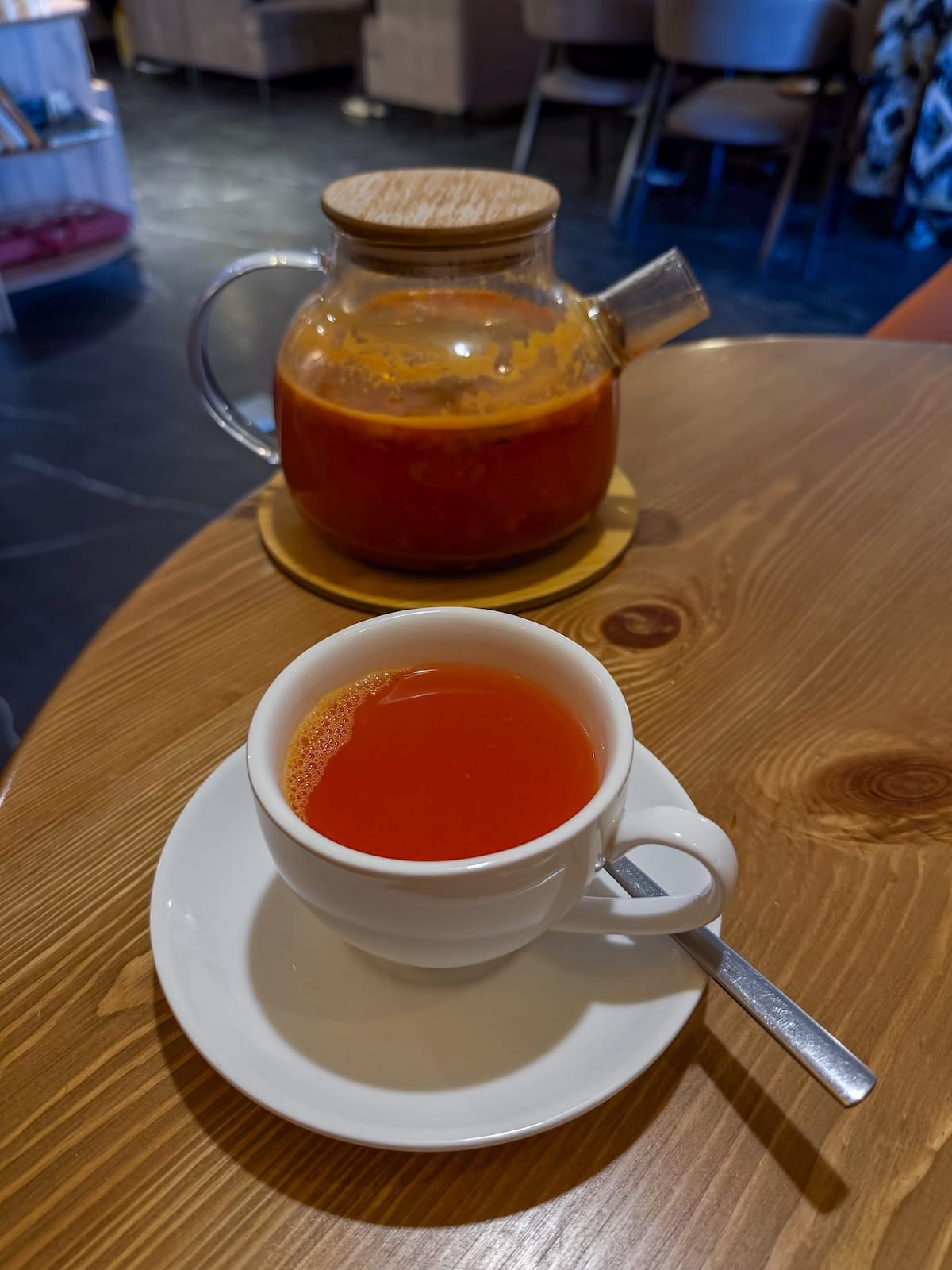 sea buckthorn tea in a pot with some poured into a mug