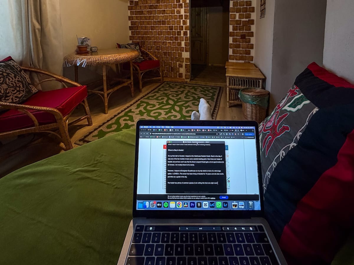 a computer open at a guesthouse on a couch
