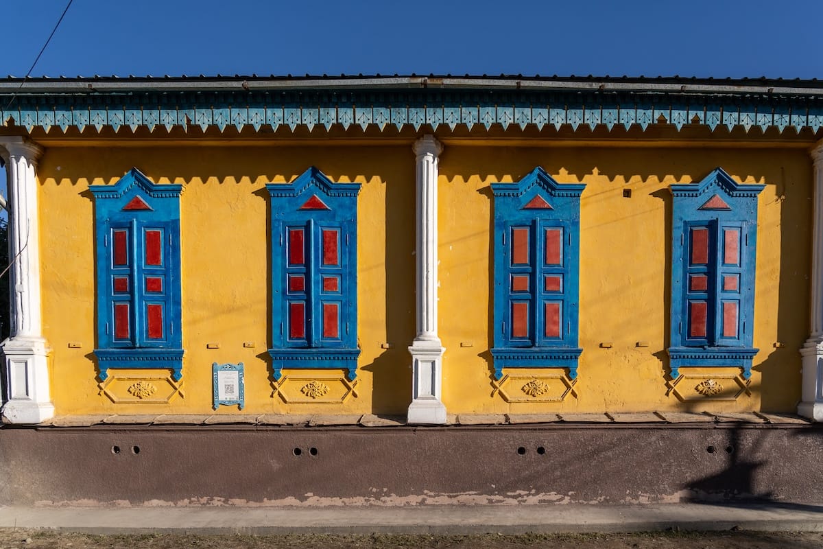 a yellow, red, and blue building in kyrgyzstan