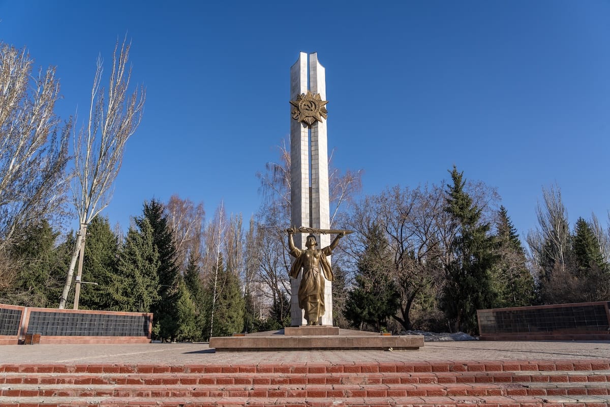 a large WW2 monument inside a park in spring