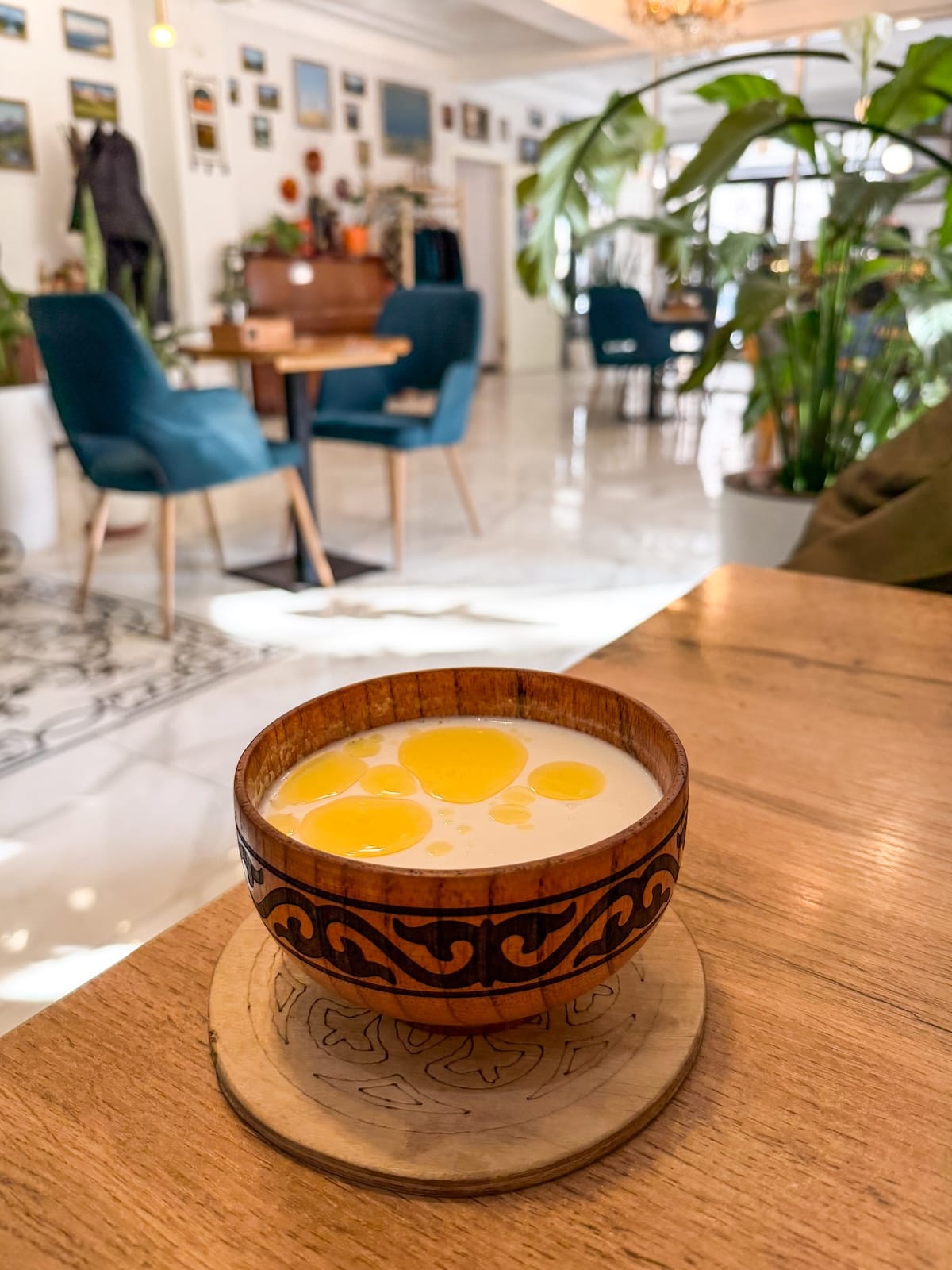 a white drink on a table in a cafe