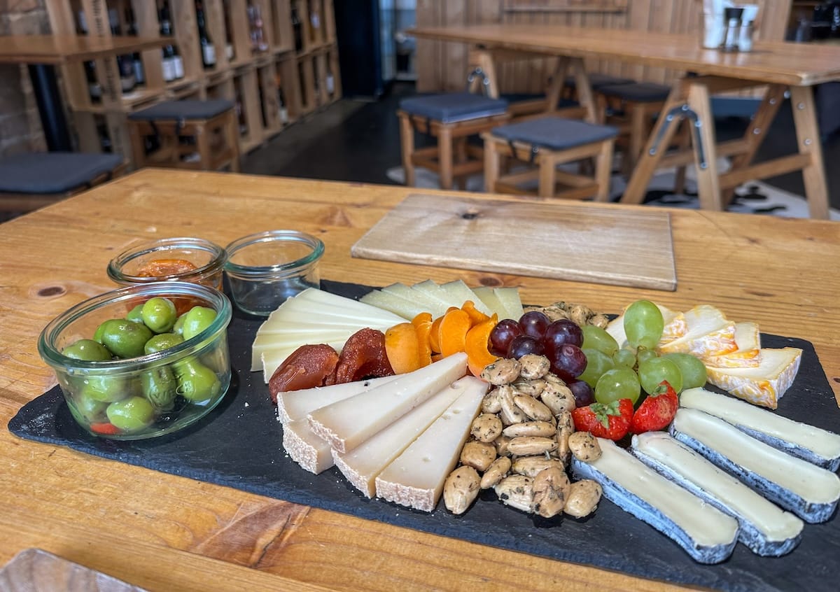 a plate of cheese and olives