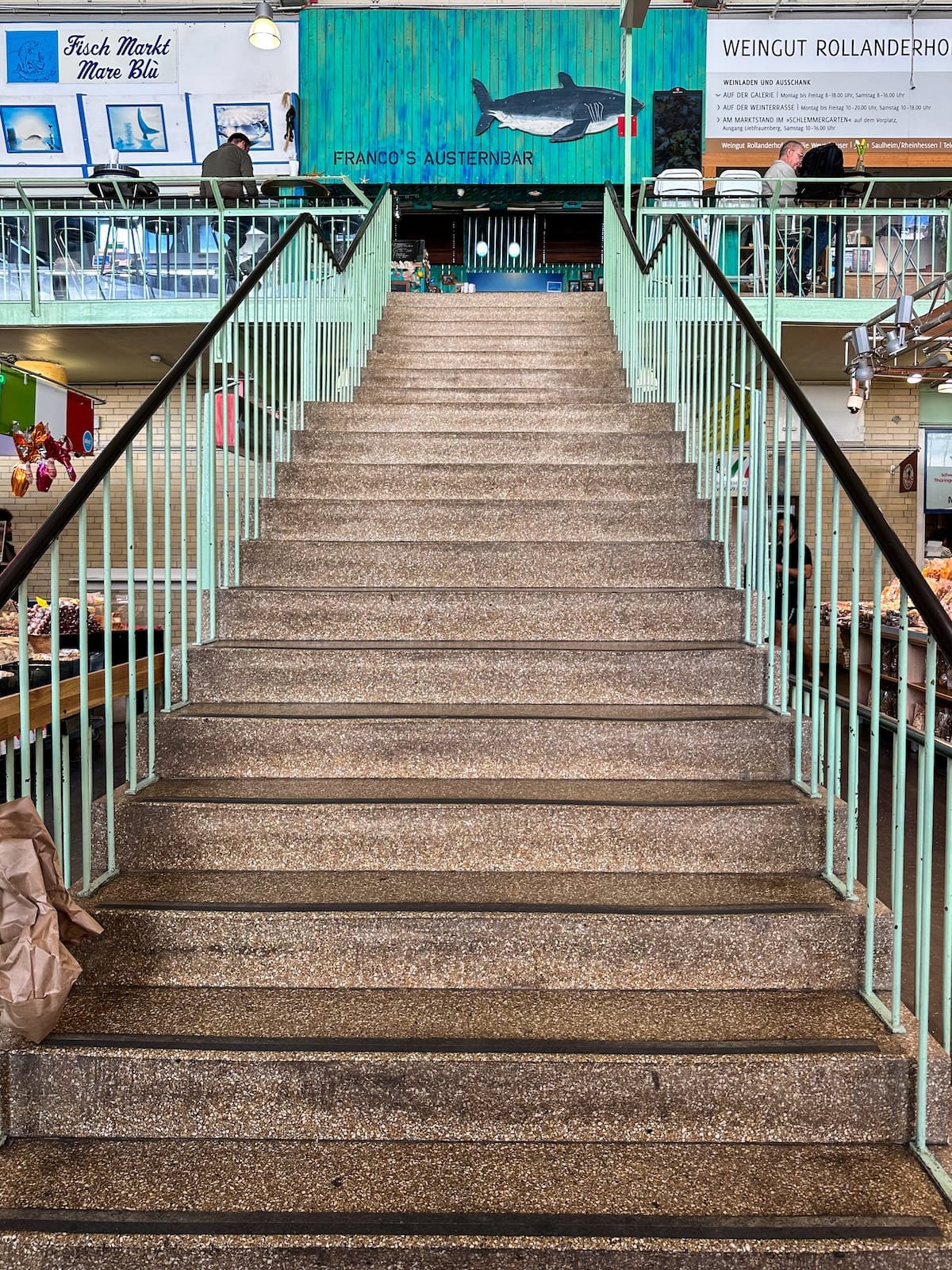 a staircase leading to vendors in a market