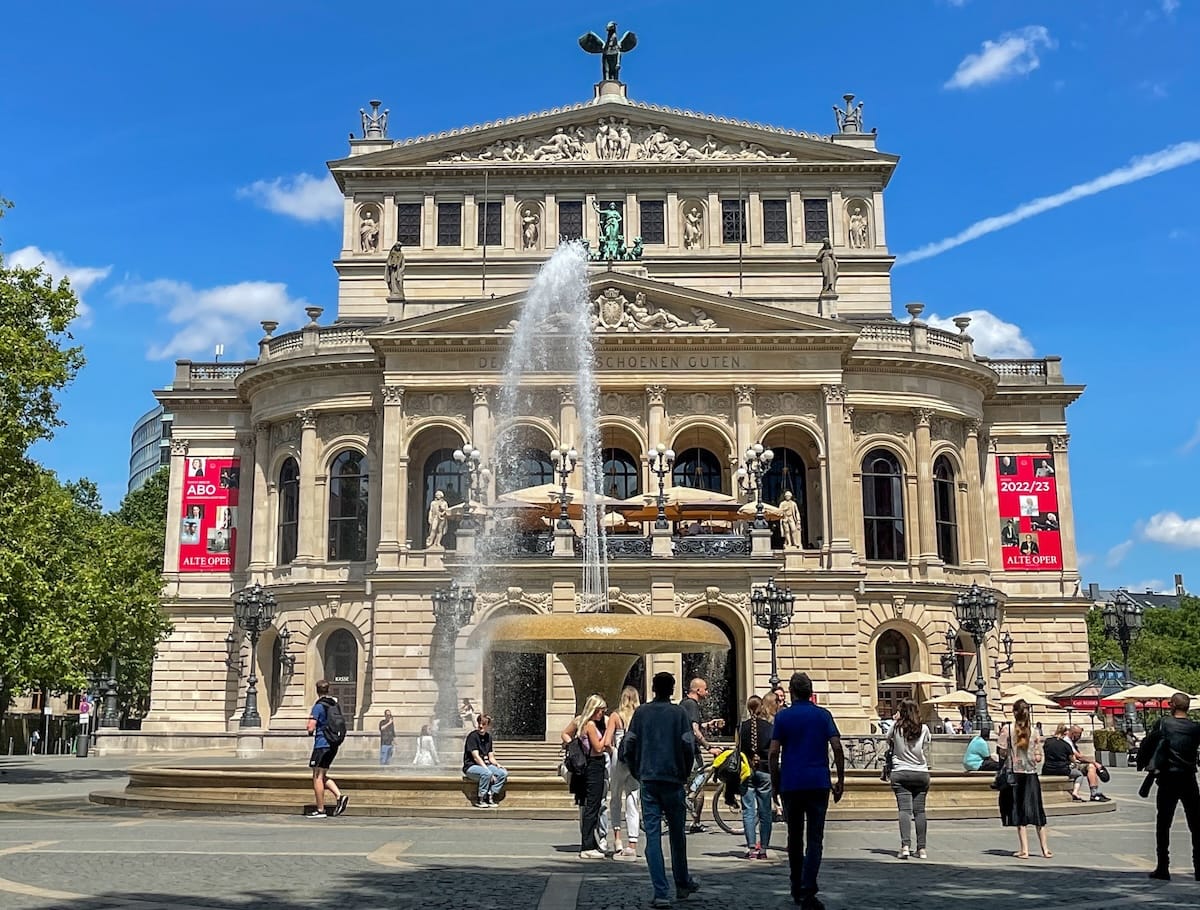 an old opera house with a fountain in front of it