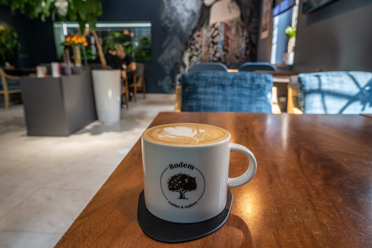 a coffee in a branded mug on a table