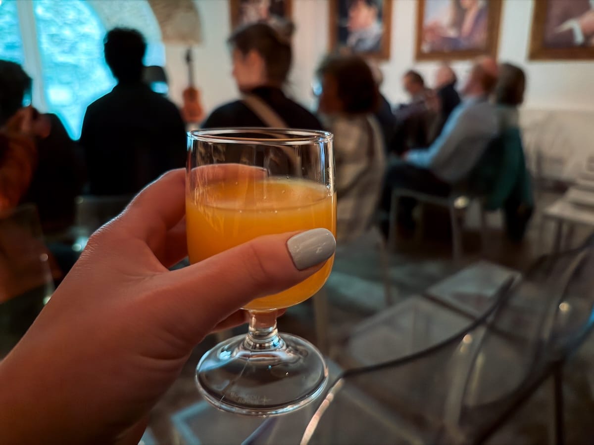 an orange juice in a womans hand
