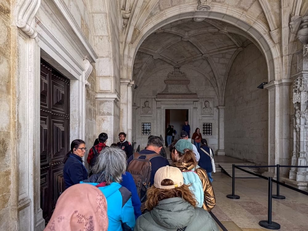 a line of people entering a monastery