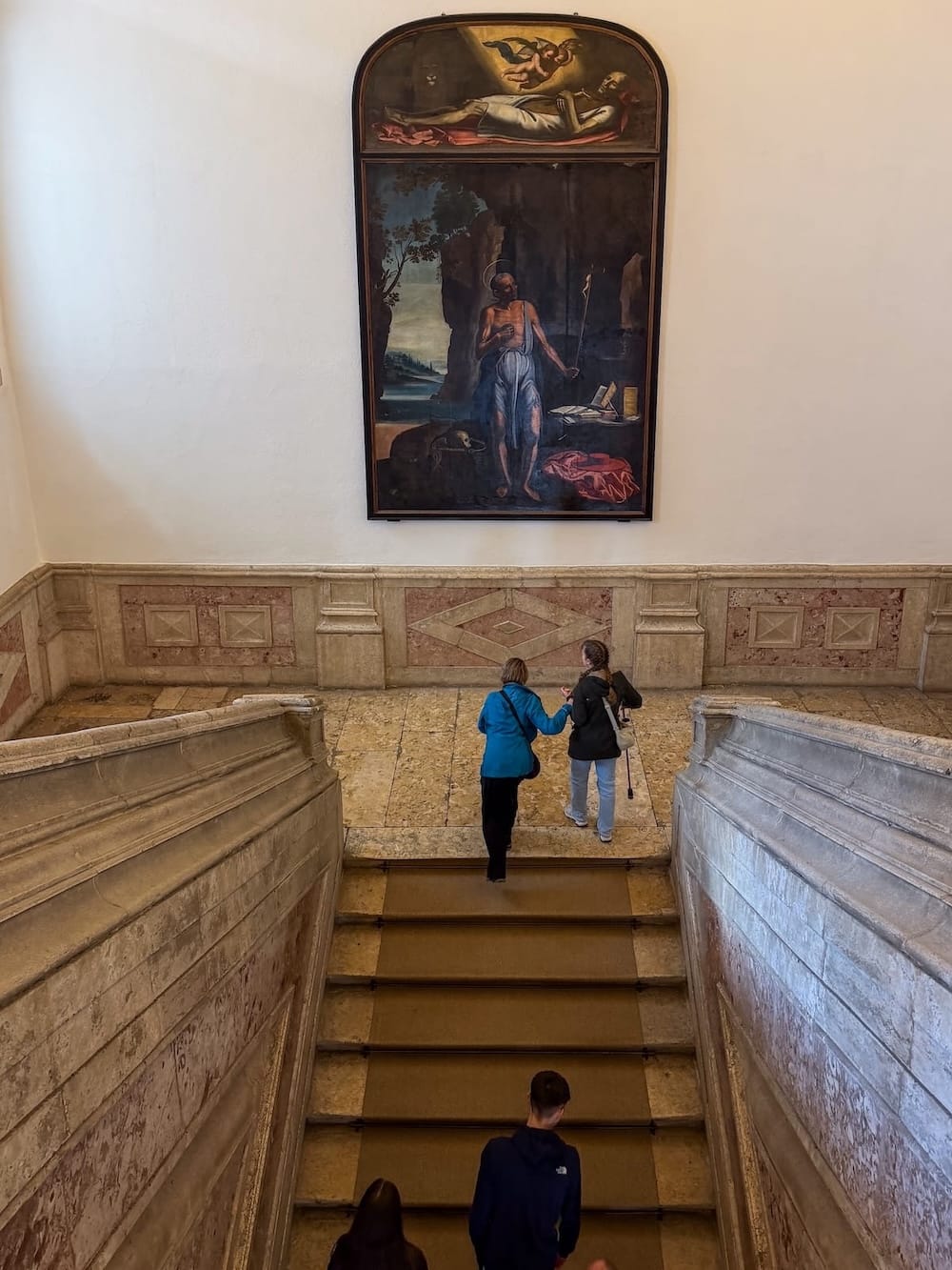 a staircase with artwork in a monastery