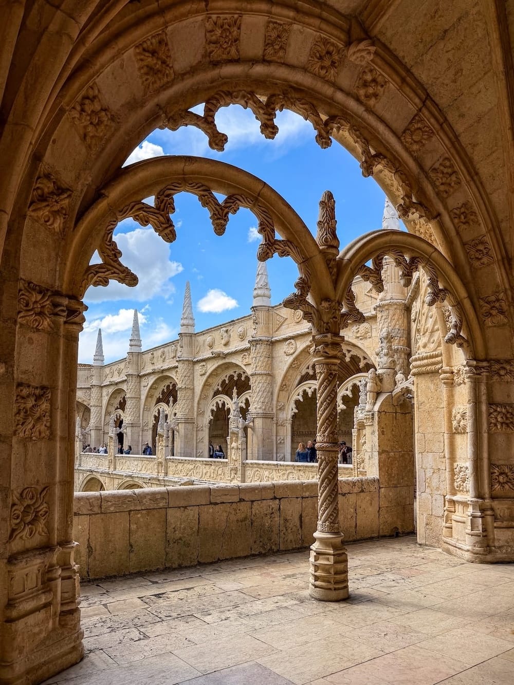 Jerónimos Monastery columns on the inside with a garden in the center