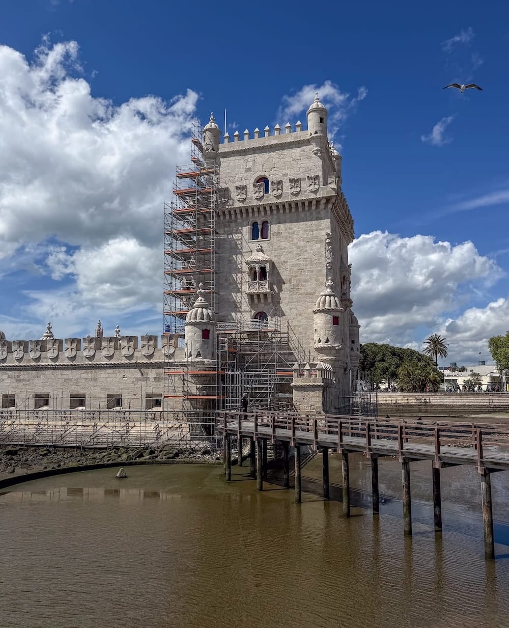 the Belém Tower in portugal with scaffolding around it