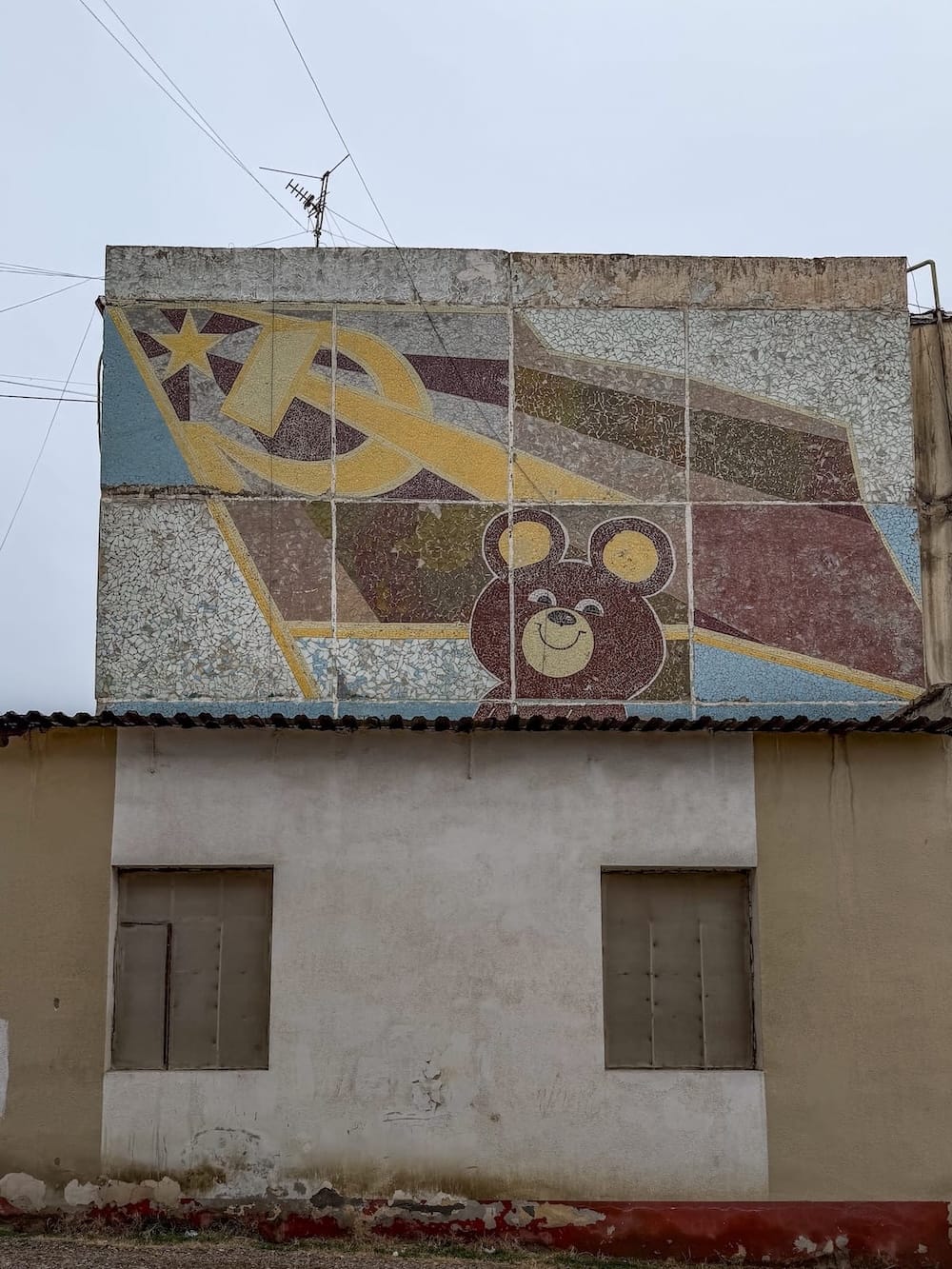 a mosaic of a bear with a hammer and sickle