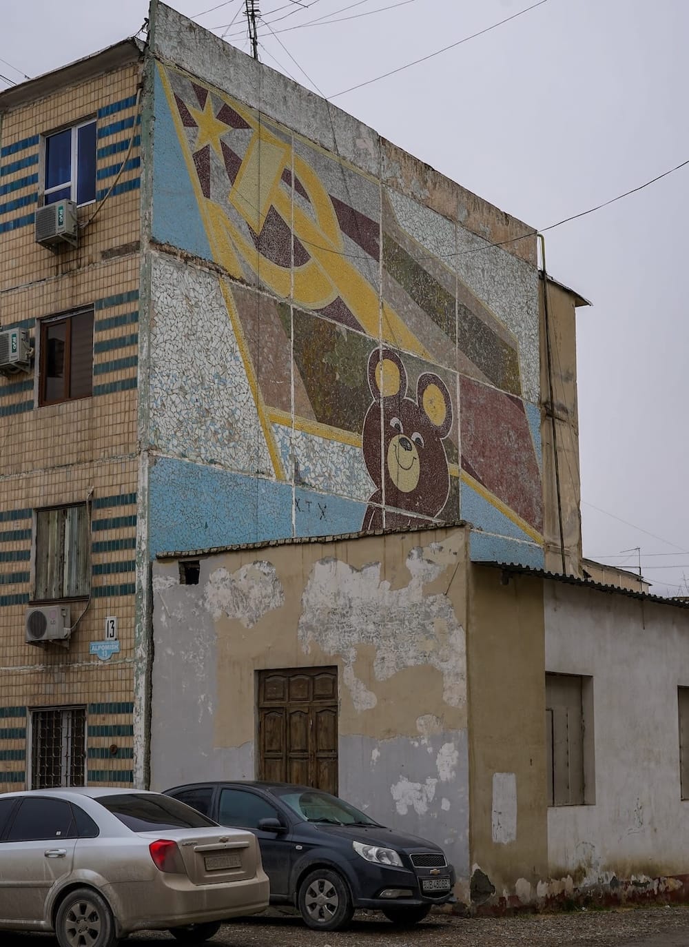 a mosaic on the side of a building of Misha the Olympic bear