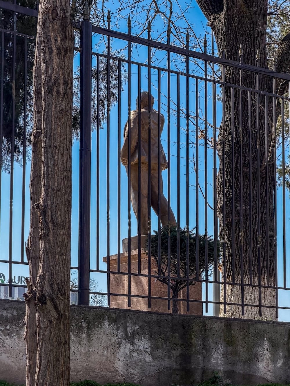 the back of a lenin statue in front of a gate
