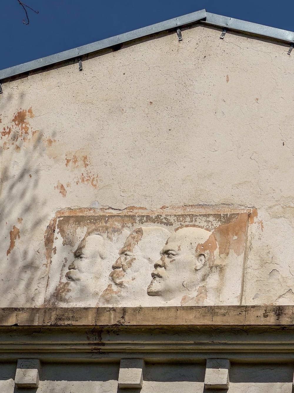 A relief of Marx, Engels, and Lenin on a building