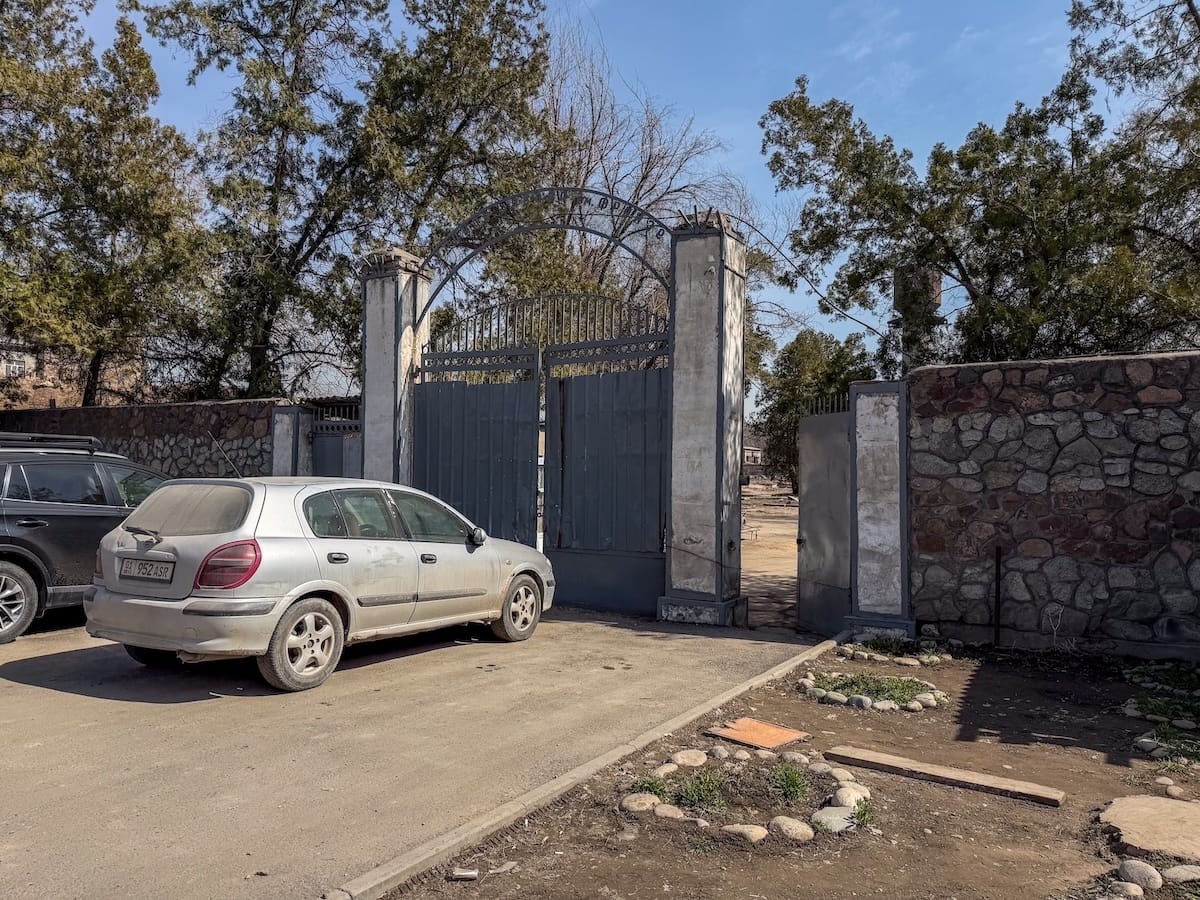 A steel gate with a car in front of it