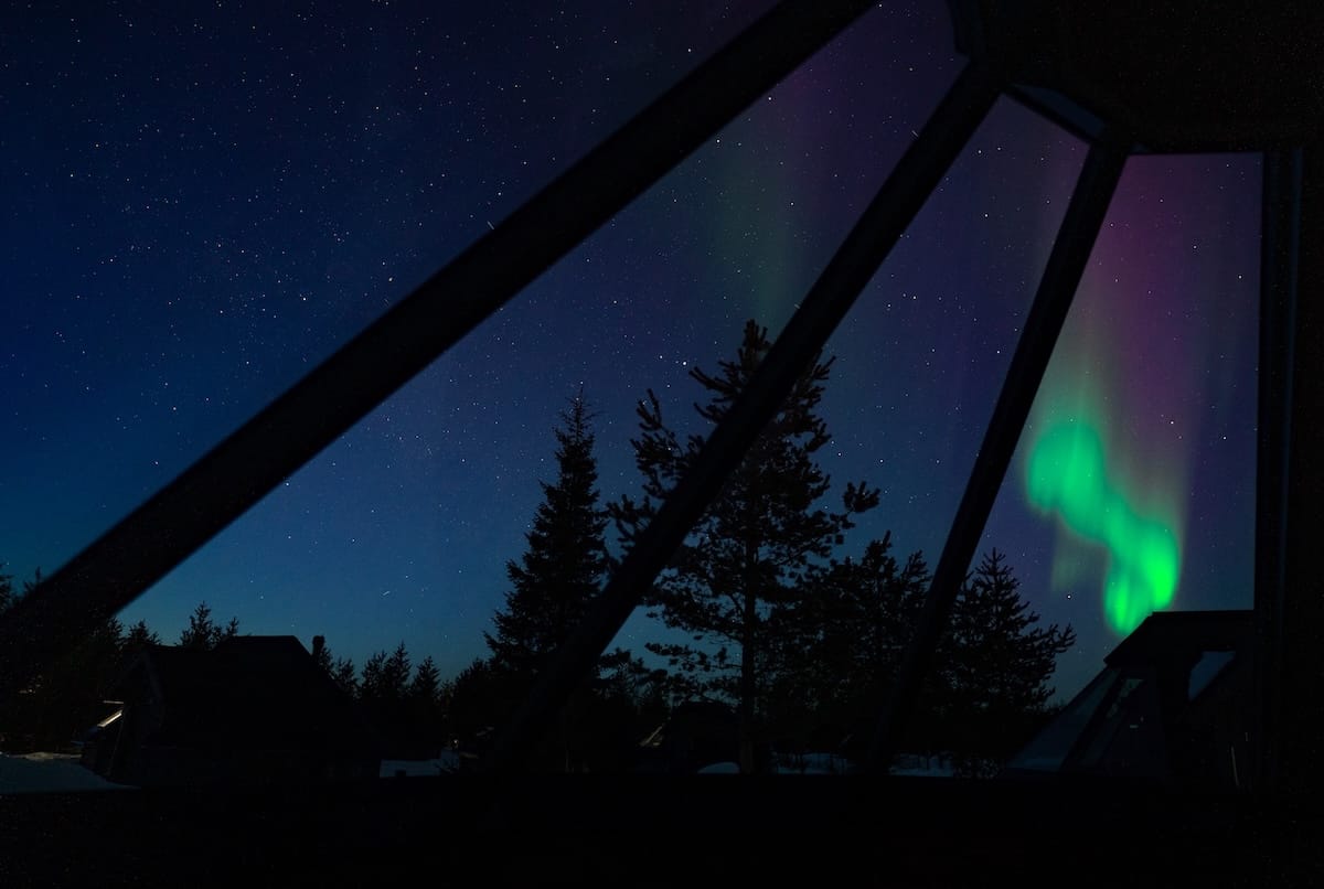 Aurora in a glass igloo cabin