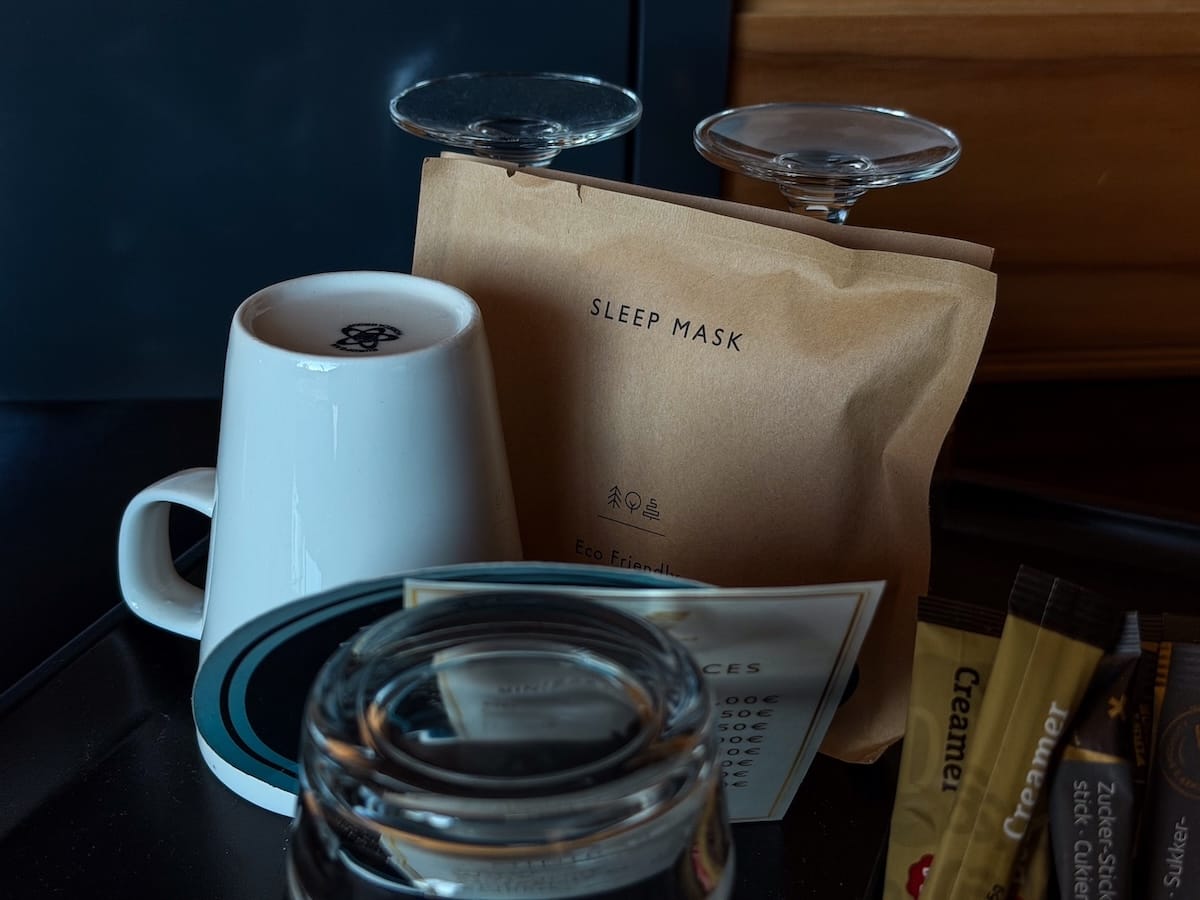 a counter with mugs, tea, coffee, sleeping mask, and more