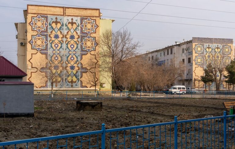 two buildings with mosaics on the sides of each