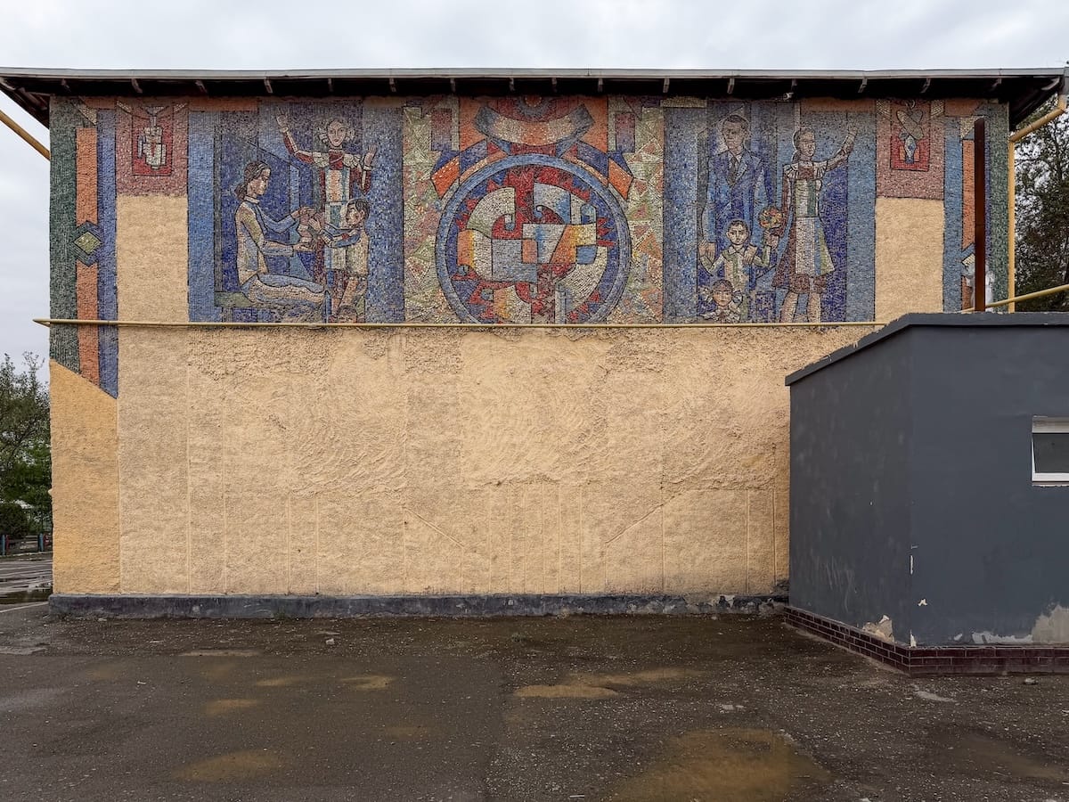a photo of a soviet-era mosaic on a school facade