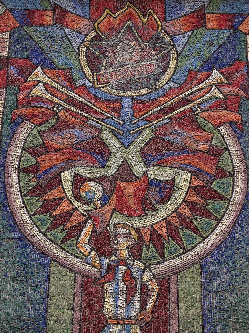 an upclose photo of a soviet-era mosaic with several colors
