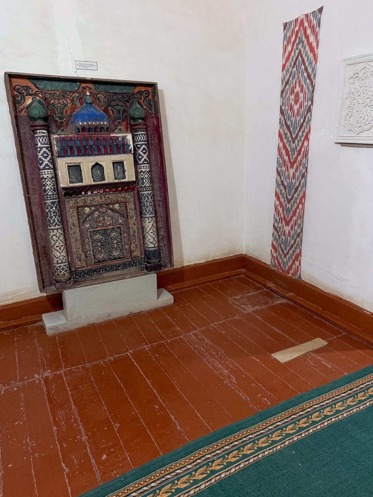 the interior of a museum with an exhibit in glass and a wooden floor