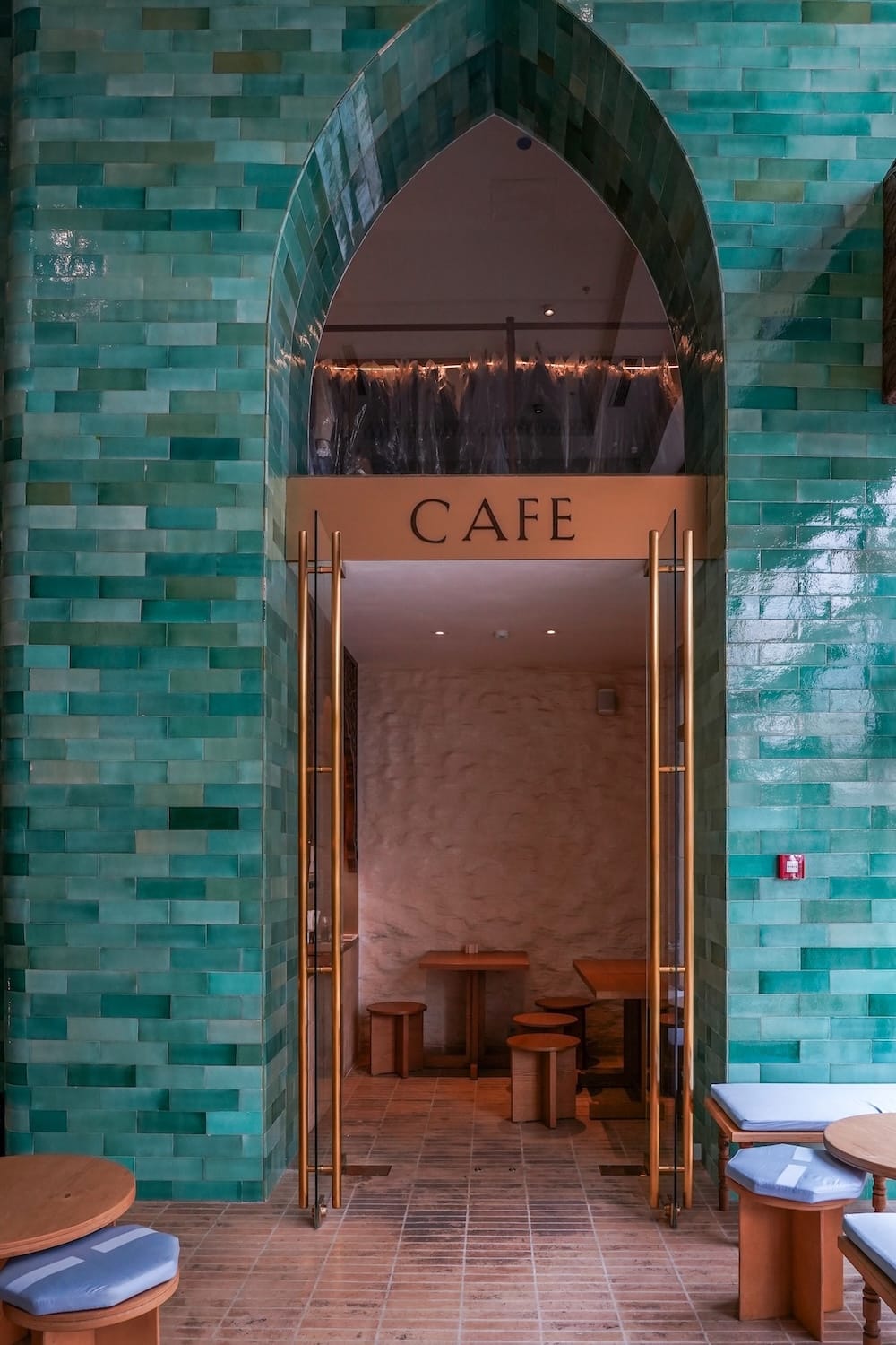 a teal doorway into a cafe