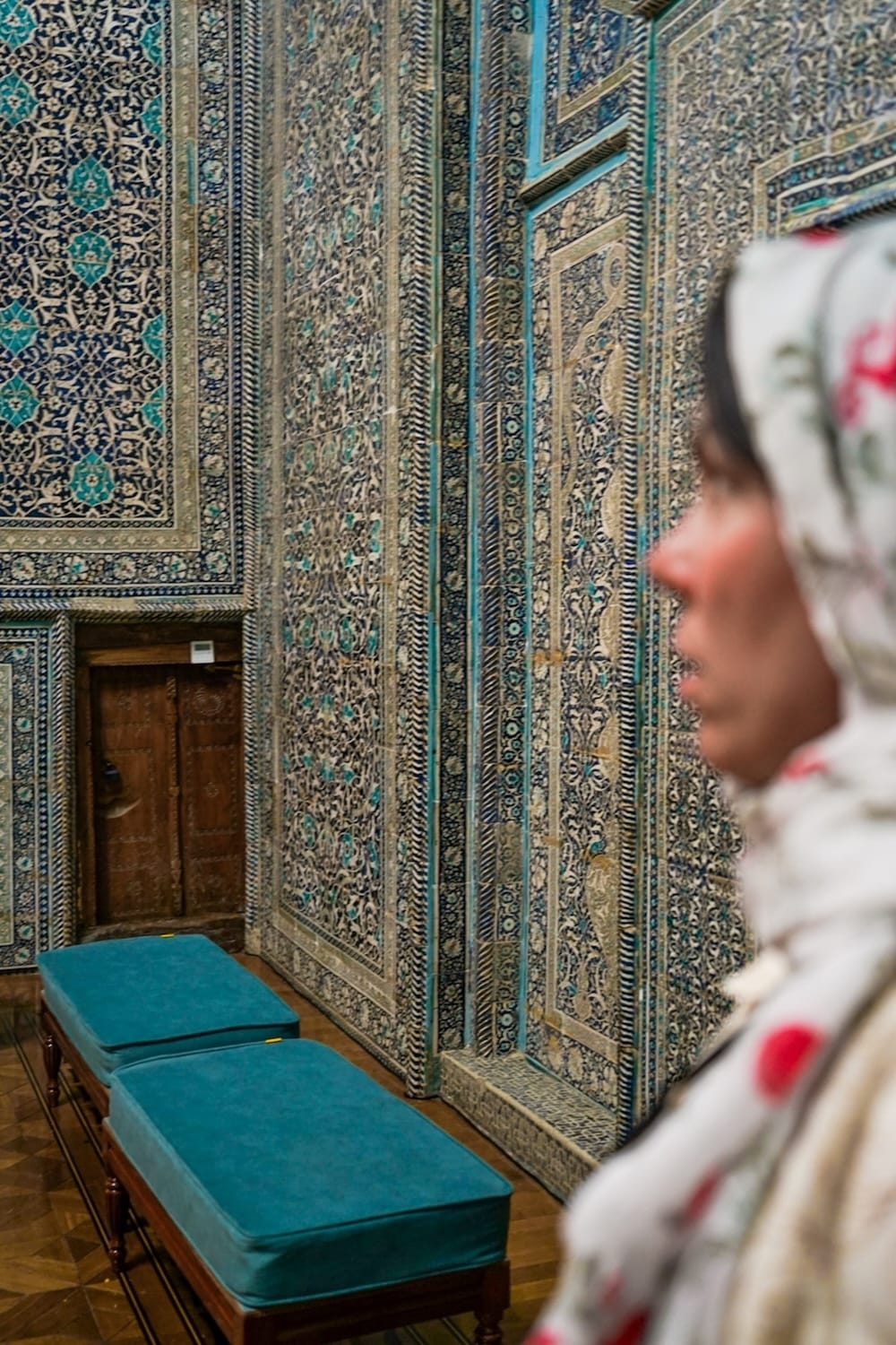 a picture of a woman inside a tiled-wall mausoleum