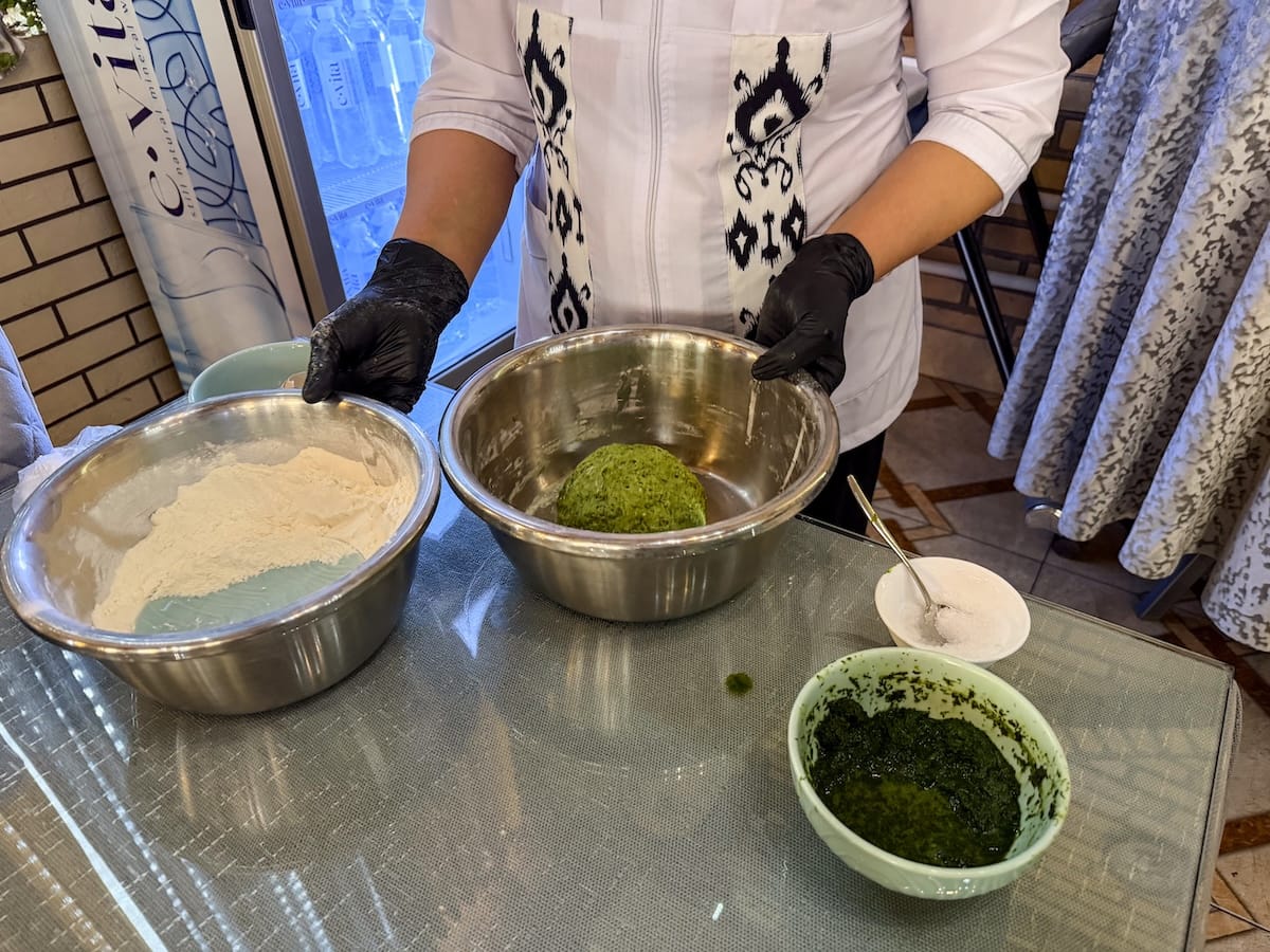 a table with three bowls on them containing ingredients to make a green dill noodle dish