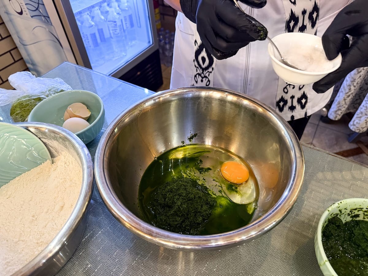 a bowl with dill, oil, and and egg inside