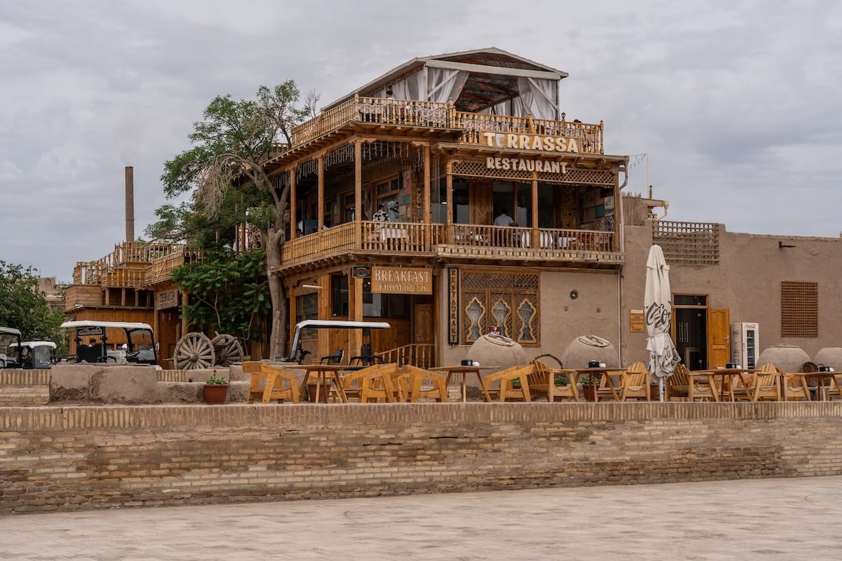 a multi-tiered wooden restaurant in khiva