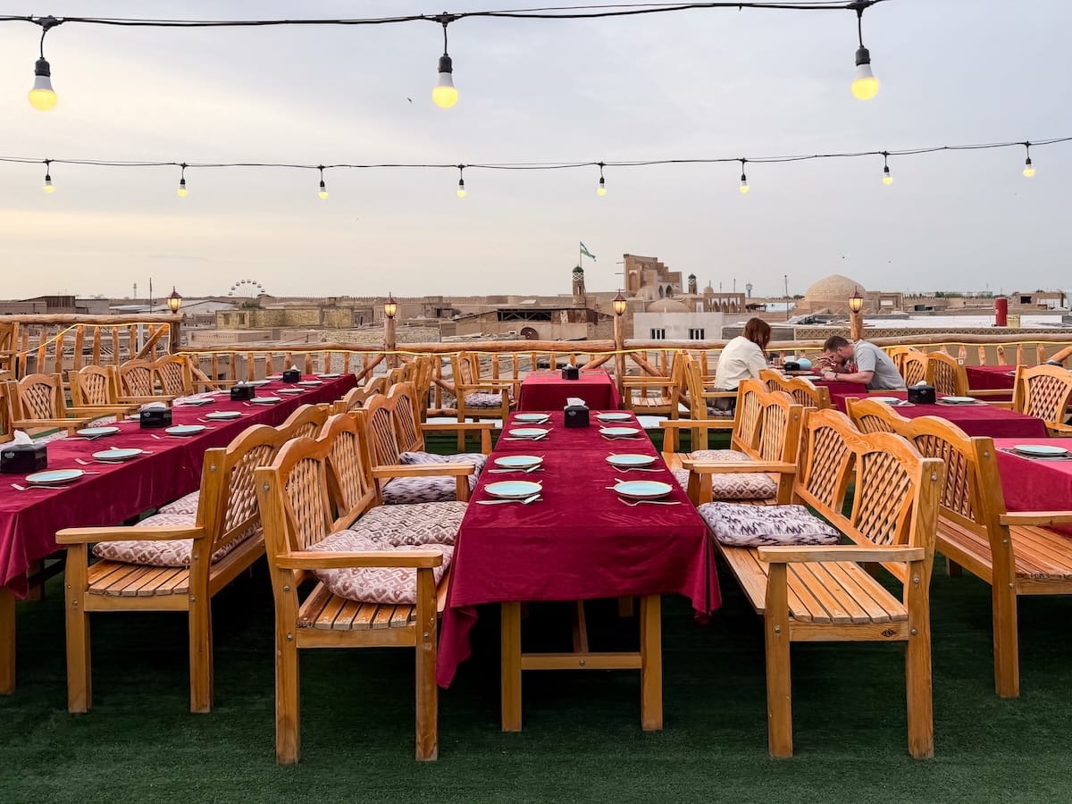 set tables on a terrace overlooking khiva, uzbekistan