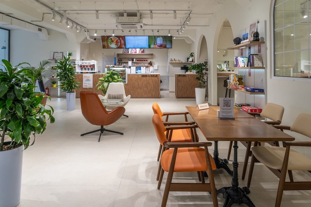 a bright cafe with orange chairs