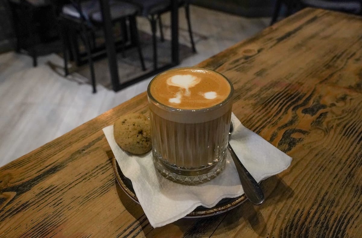 a flat white on a table in a cafe