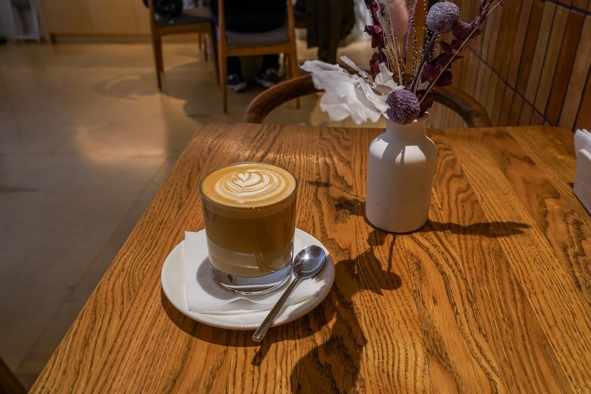 a flat white on a table in a cafe