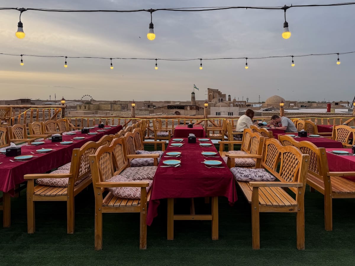 A terrace with a table with a large red cloth on it in khiva