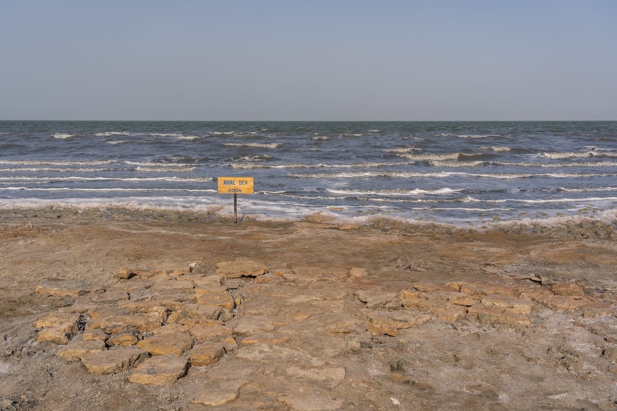 the aral sea in uzbekistan with a sign saying '2026' to see where the shoreline started this year