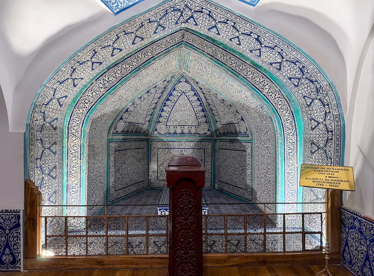 a mausoleum in khiva - a corner of a room with beautiful teal/blue tiles